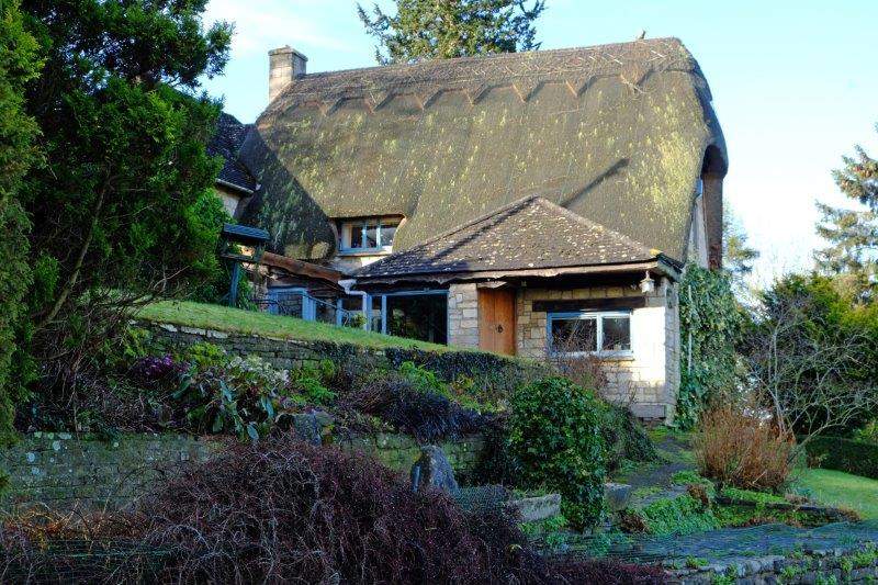 Past a thatched cottage