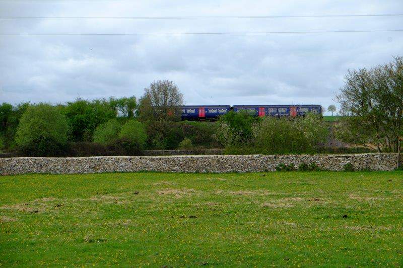 A train passes by on the nearby railway line