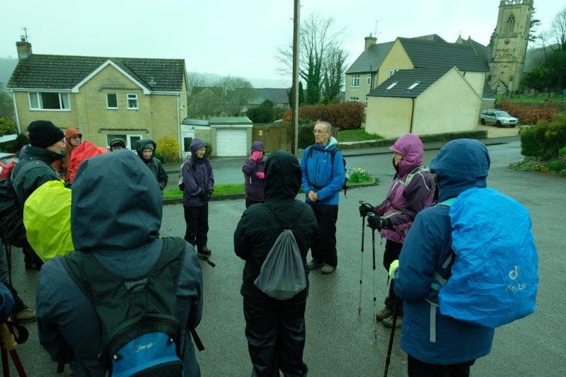 Hoods up. Waterproof covers on rucksacks. It's raining