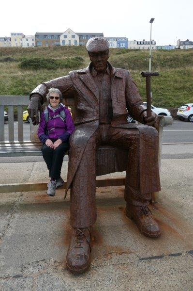 Scarborough North Beach - Heather giving scale to statue of soldier who  was much affected by the liberation of a concentration camp in WW2.