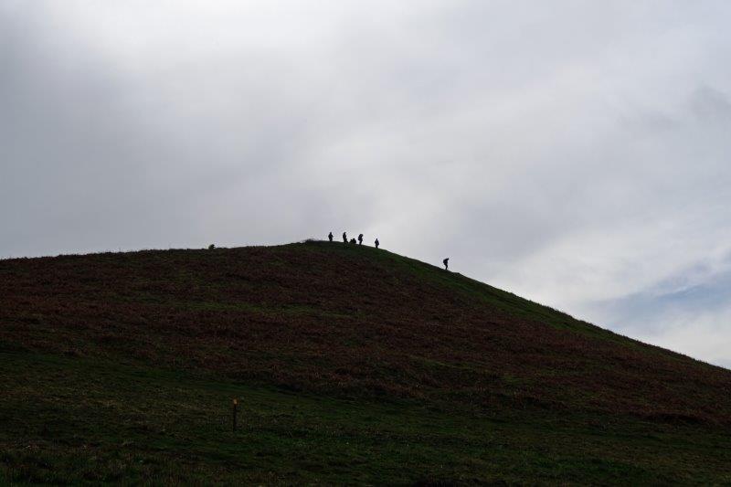 Those who climb the peak silhouetted on  the top