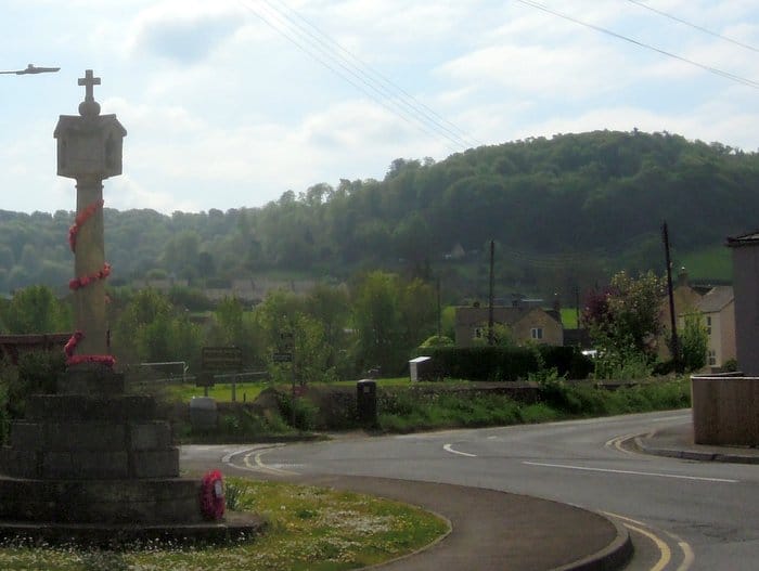 The wooded Cotswold escarpment up behind King's Stanley village