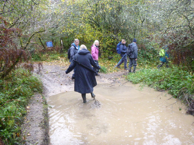 Janet demonstrates the depth of the puddle at Whitehall Bridge