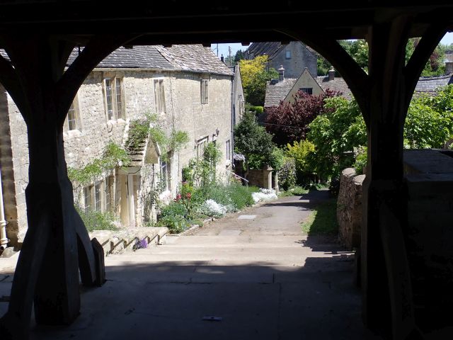 Charming countryside village with stone houses and greenery.