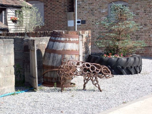 Rustic garden decor with barrel and metal sculpture