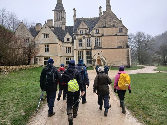 Group hiking towards large historic building