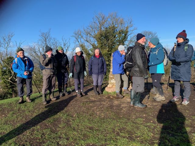 Group hiking on a sunny day, winter gear.
