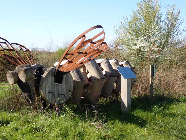 Bee sculptures in a grassy field.