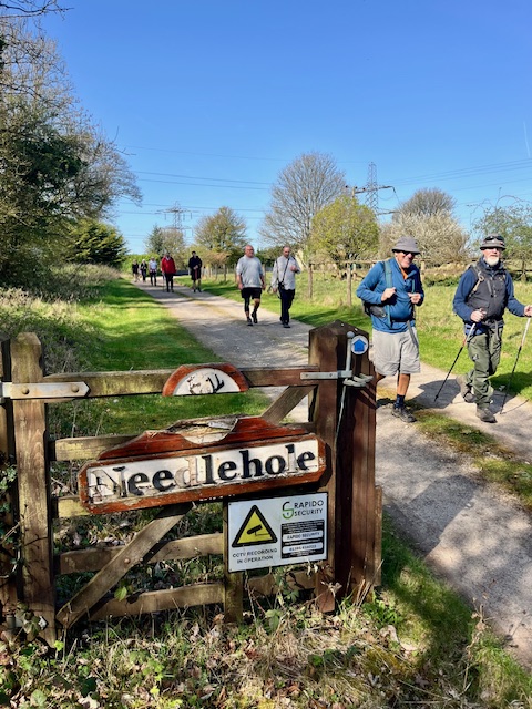 Hikers walking along a countryside path.